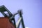 Crane for industrial handling of goods in the port with blue sky in the back