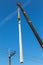 Crane lifting electricity power pole.