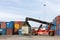 Crane lifting up container in the cargo at the port.