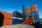 Crane lifting up container in yard.  Forklift truck lifting cargo container in shipping yard