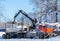 Crane loading cut forest in winter time