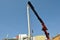 Crane lowering concrete beam in urban construction in Brazil, South America, bottom-up view