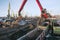 Crane manipulator unloads coal at the seaport.