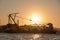 Crane ship docking in a port at sunset