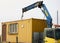 Crane truck unloading portable workers house container booth