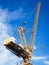 Crane work in construction site with blue sky background