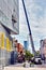 A crane and workers on a lift platdorm cleaning the windows of a building