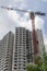 Crane working at a construction site to build a tall housing estate