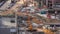 Cranes and bulldozers working at construction site of new skyscraper aerial timelapse.