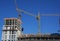 Cranes construction. Building construction growth and global construction industry concept