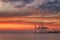 Cranes and industrial cargo ships in Varna port at sunset