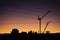 Cranes, Power Lines and Industrial Factories Silhouetted Against the Sunset