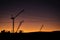 Cranes, Power Lines and Industrial Factories Silhouetted Against the Sunset