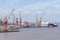 Cranes and ships at large dockyard, panorama.