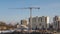 Cranes working on construction site residential housing estate building technology in process