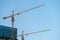 cranes are working under the blue sky, for skyscrapers construction, in Zhuhai city, CHINA.