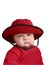 Cranky baby in red hat.