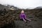 Cranky little girl resting on the lava fields of Mount Etna
