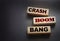 Crash boom bang words on wooden blocks on black background. Unexpected crisis, failure or bankruptcy business concept. End of