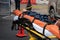 A crash dummy mannequin displayed on a stretcher on the street