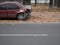 Crashed abandoned car on pavement at city street