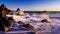 Crashing waves at dreamy california beach at sunset