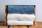 Crate with clean soft towels on wooden table