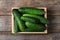 Crate full of fresh ripe cucumbers, top view