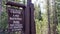 Crater Lake National Park West Entrance Sign with forest background