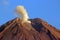 The crater at the peak of Mount Semeru emitting smoke