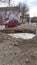 A crater on road filled with water after artillery shelling in Chernihiv.