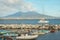 Crater Vesuvius, catamaran and dinghies in small port in Naples.