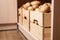 Crates with potatoes on shelf. Orderly storage