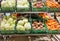 Crates with ripe fresh cabbage, carrots and beetroots on shelves