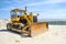 Crawler caterpillar bulldozer push sand beach