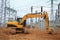 Crawler excavator at construction site of electrical substation of industrial sector