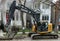 A crawler excavator digs dirt on a Chicago residential