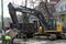 A crawler excavator digs dirt next to a dump truck in Chicago