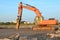 Crawler excavator with hydraulic hammer for the destruction of concrete and hard rock at the construction site.