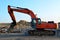 Crawler excavator with hydraulic hammer for the destruction of concrete and hard rock at the construction site.