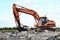 Crawler excavator with hydraulic hammer for the destruction of concrete and hard rock at the construction site. Replacing a