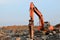 Crawler excavator with hydraulic hammer for the destruction of concrete and hard rock at the construction site. Salvaging and