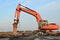 Crawler excavator with hydraulic hammer for the destruction of concrete and hard rock at the construction site. Salvaging and