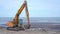 Crawler excavator moves on the beach