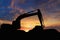 Crawler excavators silhouette are digging the soil in the construction site.