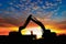 Crawler excavators silhouette are digging the soil in the construction site.