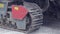 Crawler tractor close-up rides on asphalt