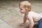 Crawling around the house. A sweet little baby boy crawling outside.