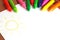 Crayons lying on a paper with painted children\'s drawing