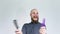 Crazy bald guy with a red beard holds two combs.Cool video for fun